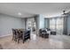 Comfortable living space with tile flooring, a sectional sofa, a modern ceiling fan, and sliding glass doors to the outside at 2731 Neverland Dr, New Smyrna Beach, FL 32168