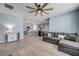 Open-concept living room featuring tile floors, modern furnishings, and seamless flow to the kitchen area at 2731 Neverland Dr, New Smyrna Beach, FL 32168