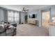 Cozy living room features a plush sectional, modern decor, and large windows that fill the space with natural light at 2731 Neverland Dr, New Smyrna Beach, FL 32168