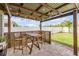 Charming backyard patio area with string lights and stylish wooden table set at 2731 Neverland Dr, New Smyrna Beach, FL 32168