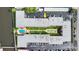 Aerial view of complex featuring a pool, shuffleboard, lush landscaping, and ample parking at 2901 N Halifax Ave # 215, Daytona Beach, FL 32118
