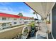 Balcony with outdoor seating and a view of the building, palm trees, and a water feature at 2901 N Halifax Ave # 215, Daytona Beach, FL 32118