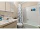 Bright bathroom features a shower-tub combination with white tiled walls, toilet and vanity at 2901 N Halifax Ave # 215, Daytona Beach, FL 32118