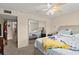 Cozy bedroom with comfortable bed, ceiling fan, mirrored closet, and carpeted floors at 2901 N Halifax Ave # 215, Daytona Beach, FL 32118