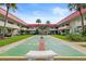 Exterior shot of the building with a shuffleboard court, grassy area, and palm trees at 2901 N Halifax Ave # 215, Daytona Beach, FL 32118