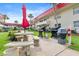 Common area features stone table and benches, charcoal grills, and lush landscaping at 2901 N Halifax Ave # 215, Daytona Beach, FL 32118