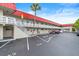 Condo featuring exterior stairs leading to the unit's private balcony with parking nearby at 2901 N Halifax Ave # 215, Daytona Beach, FL 32118