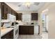 Traditional kitchen features white appliances, tile flooring and wood cabinets at 2901 N Halifax Ave # 215, Daytona Beach, FL 32118