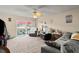 Cozy living room featuring comfortable seating, ceiling fan, and sliding glass doors to the balcony at 2901 N Halifax Ave # 215, Daytona Beach, FL 32118