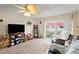 The well-lit living room includes a TV, ceiling fan and sliding glass doors to the outside at 2901 N Halifax Ave # 215, Daytona Beach, FL 32118