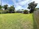 Private backyard featuring mature trees and a lush lawn, offering a serene and relaxing outdoor space at 2918 Mango Tree Dr, Edgewater, FL 32141
