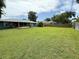 Large backyard with a screened-in porch and a well-maintained lawn, perfect for relaxation and entertainment at 2918 Mango Tree Dr, Edgewater, FL 32141