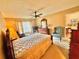 Comfortable bedroom featuring a ceiling fan, large window, and carpeted floors at 2918 Mango Tree Dr, Edgewater, FL 32141