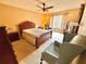 Comfortable bedroom with a ceiling fan, neutral colors, and a large window at 2918 Mango Tree Dr, Edgewater, FL 32141