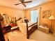 Cozy bedroom featuring a four-post bed, neutral paint, and comfortable furniture at 2918 Mango Tree Dr, Edgewater, FL 32141
