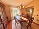 Elegant dining room with chandelier lighting, formal dining set, and warm, inviting ambiance at 2918 Mango Tree Dr, Edgewater, FL 32141
