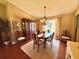 Elegant dining room showcasing a chandelier, formal dining set, and abundant natural light at 2918 Mango Tree Dr, Edgewater, FL 32141