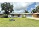 Charming single-story home with a well-manicured lawn and a welcoming front porch at 2918 Mango Tree Dr, Edgewater, FL 32141