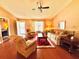 Cozy living room featuring wood floors, comfortable seating, and a bright, inviting atmosphere at 2918 Mango Tree Dr, Edgewater, FL 32141