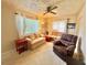 Inviting living room with bright natural light, comfortable furniture, and a ceiling fan at 2918 Mango Tree Dr, Edgewater, FL 32141