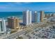 Stunning aerial view showcases oceanfront condos, a pristine beach, and ample parking at 3023 S Atlantic Ave # 8010, Daytona Beach, FL 32118