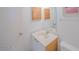Bright bathroom featuring a white vanity with a light countertop and wooden shuttered cabinet at 3023 S Atlantic Ave # 8010, Daytona Beach, FL 32118