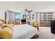 Bright bedroom featuring a wood bed frame, ceiling fan, and access to a private balcony at 3023 S Atlantic Ave # 8010, Daytona Beach, FL 32118