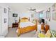 Relaxing bedroom featuring a wood bed frame, ceiling fan, and access to a private balcony at 3023 S Atlantic Ave # 8010, Daytona Beach, FL 32118