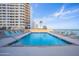 Enjoy the outdoor pool area with lounge chairs and beautiful ocean views at Oceans Atrium at 3023 S Atlantic Ave # 8010, Daytona Beach, FL 32118