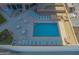 Aerial view of the community pool with tables, chairs, and loungers at 3023 S Atlantic Ave # 8010, Daytona Beach, FL 32118