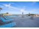 Enjoy the outdoor pool area with lounge chairs, tables, and beautiful ocean views at 3023 S Atlantic Ave # 8010, Daytona Beach, FL 32118