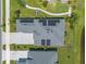 Overhead view of a home with solar panels, driveway, and manicured lawn, near a pond at 3027 Portofino Blvd, New Smyrna Beach, FL 32168