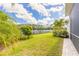 Manicured lawn leads to a serene lake, creating a picturesque backyard retreat at 3027 Portofino Blvd, New Smyrna Beach, FL 32168