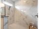 Beautiful shower with large marble-look tile, a hand shower, and a small window for natural light at 3027 Portofino Blvd, New Smyrna Beach, FL 32168