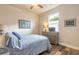 Bedroom featuring a bed with a blue patterned comforter, a dresser, and a ceiling fan at 3027 Portofino Blvd, New Smyrna Beach, FL 32168