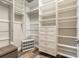 Organized walk-in closet with built-in shelving, drawers, and space for shoe storage at 3027 Portofino Blvd, New Smyrna Beach, FL 32168