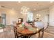 Charming dining area with a wood table and view into the living room and modern kitchen at 3027 Portofino Blvd, New Smyrna Beach, FL 32168