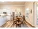 Dining area and kitchen with wood-look floors, stainless appliances and natural light at 3027 Portofino Blvd, New Smyrna Beach, FL 32168
