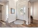 Foyer features a white front door, a decorative wreath, and gray rug on wood-look flooring at 3027 Portofino Blvd, New Smyrna Beach, FL 32168