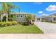 Charming home with well-kept lawn, palm trees, and paver driveway providing curb appeal at 3027 Portofino Blvd, New Smyrna Beach, FL 32168
