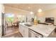 Open concept kitchen boasts granite countertops, stainless steel appliances, and views of the dining area at 3027 Portofino Blvd, New Smyrna Beach, FL 32168