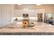 Modern kitchen features stainless steel appliances, white cabinetry, granite countertops, and a large center island at 3027 Portofino Blvd, New Smyrna Beach, FL 32168