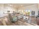 Spacious living room features a modern kitchen, comfortable seating, and wood-look floors at 3027 Portofino Blvd, New Smyrna Beach, FL 32168