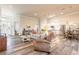 Expansive open-concept living area with wood-look floors, comfortable seating, and a modern kitchen at 3027 Portofino Blvd, New Smyrna Beach, FL 32168