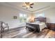 Comfortable bedroom featuring a decorative tray ceiling, dark wood furniture, and a window with a lake view at 3027 Portofino Blvd, New Smyrna Beach, FL 32168