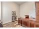 An office area includes a wooden desk with rolling chair, built-in shelving and wood-look flooring at 3027 Portofino Blvd, New Smyrna Beach, FL 32168
