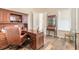 Office area features wood-look floors, wooden desk and cabinets, and natural light at 3027 Portofino Blvd, New Smyrna Beach, FL 32168