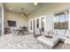 Relaxing screened patio with ceiling fan and stylish outdoor furniture at 3027 Portofino Blvd, New Smyrna Beach, FL 32168