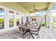 Outdoor living space boasts comfortable furniture and a beautiful view of the back yard at 3027 Portofino Blvd, New Smyrna Beach, FL 32168