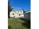 View of the back of the house and garage from the yard on a sunny day at 306 Murray St, New Smyrna Beach, FL 32168